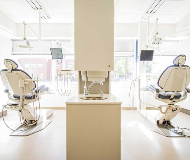 Two dental chairs in a procedure room.